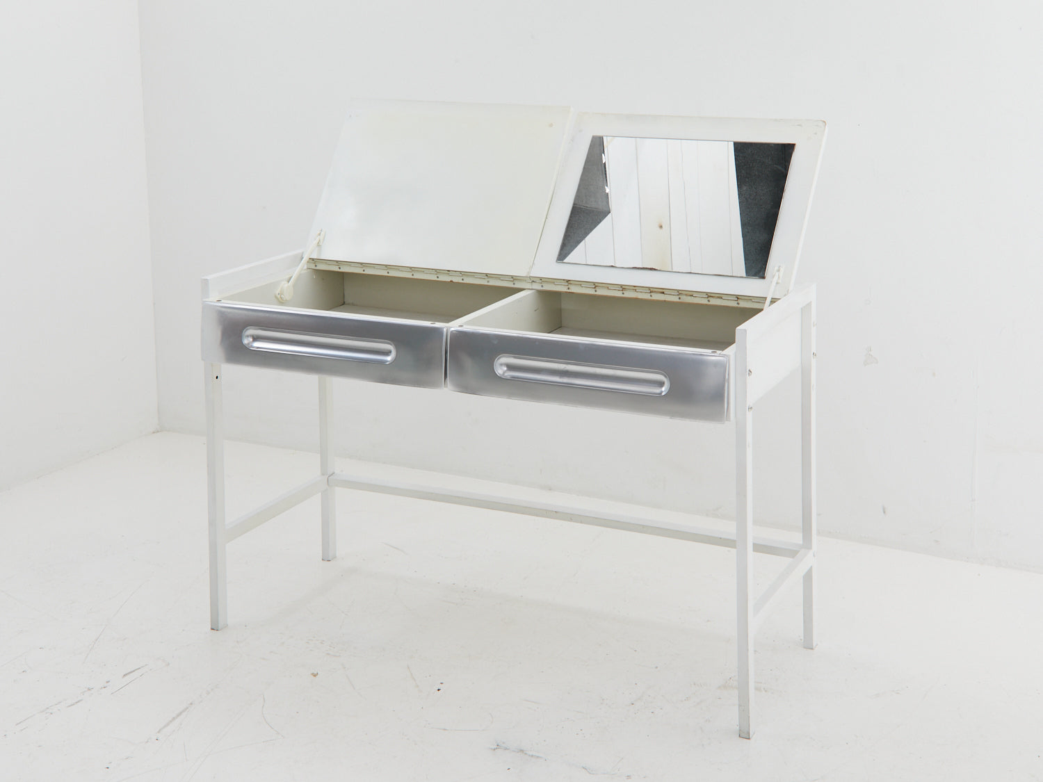View of both flip-tops extended on a white and silver desk in the style of Raymond Loewy