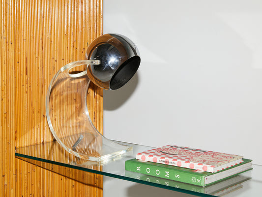 Close up of a glass shelf an interior of a pencil reed etagere from the 1970s