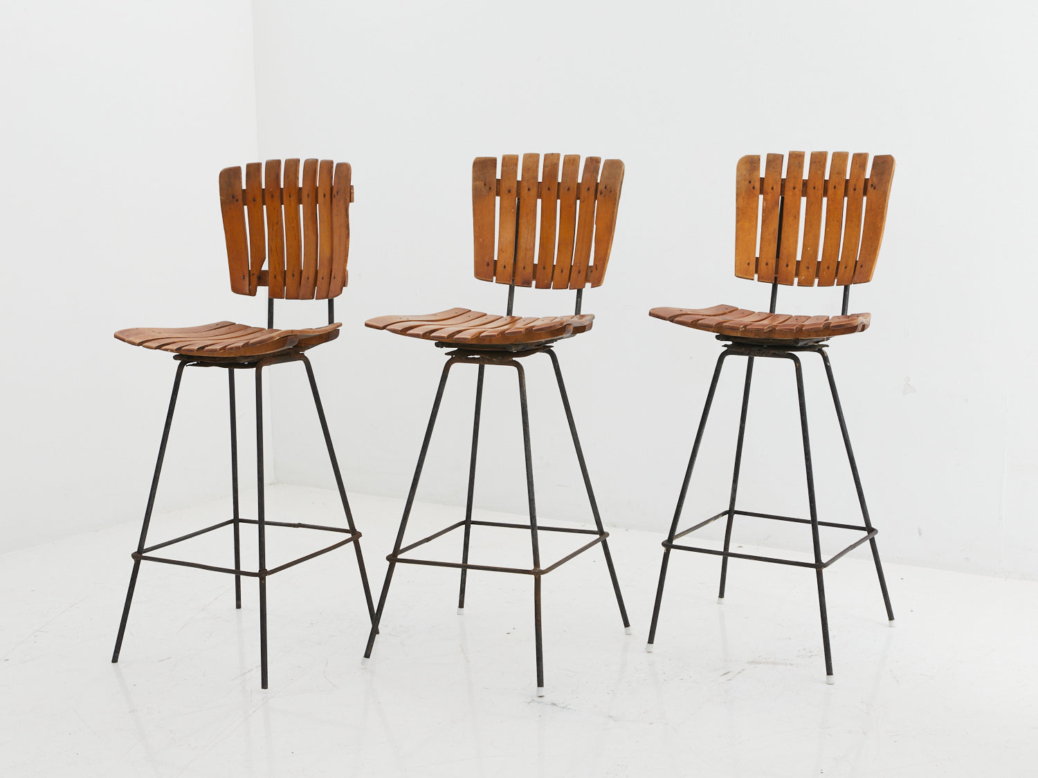 Set of 3 iron and wood stools by Arthur Umanoff
