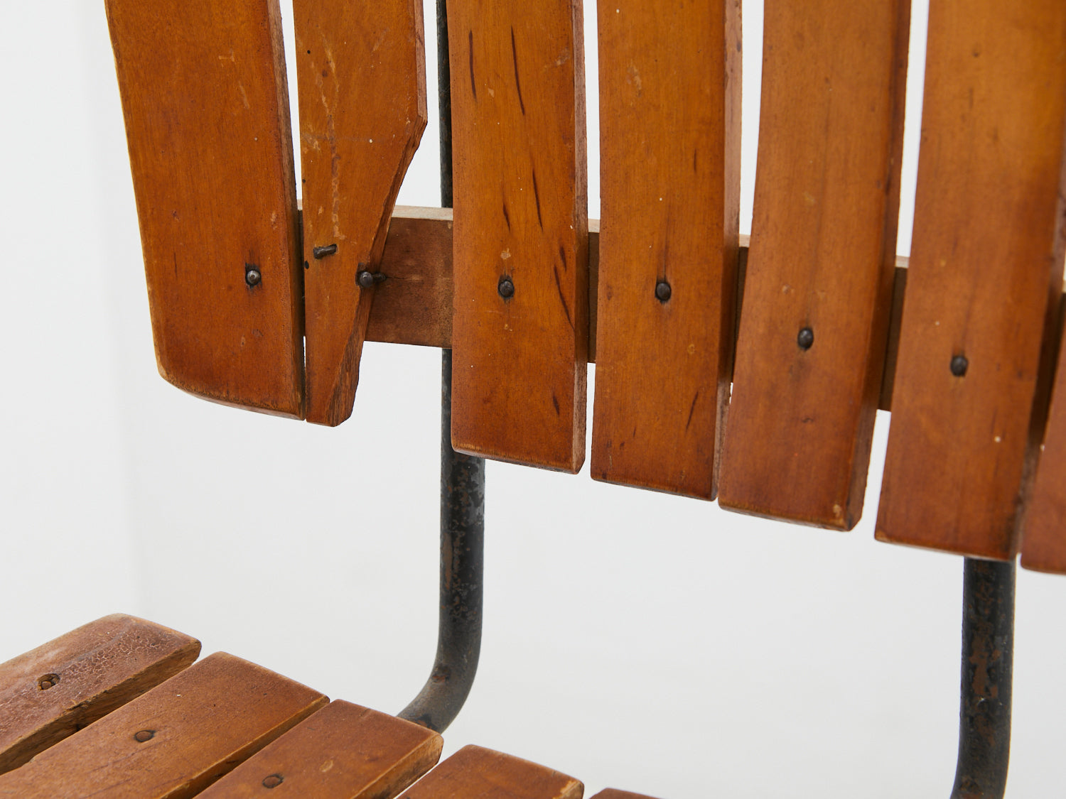 Close up of wood loss to 1950s Iron & Wood Stool by Arthur Umanoff