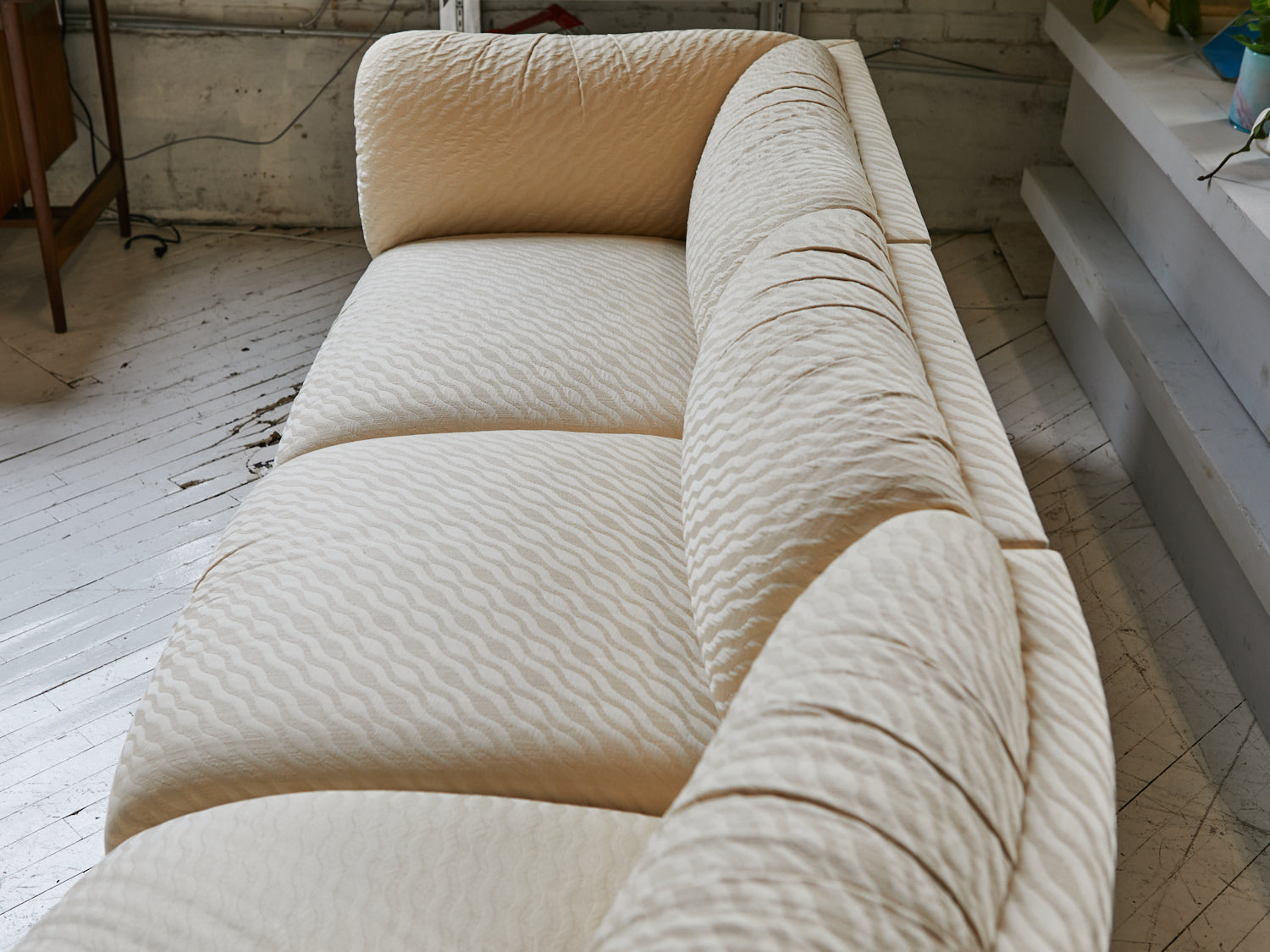 Close up of a 5-piece cream sectional with custom upholstery circa 1980s