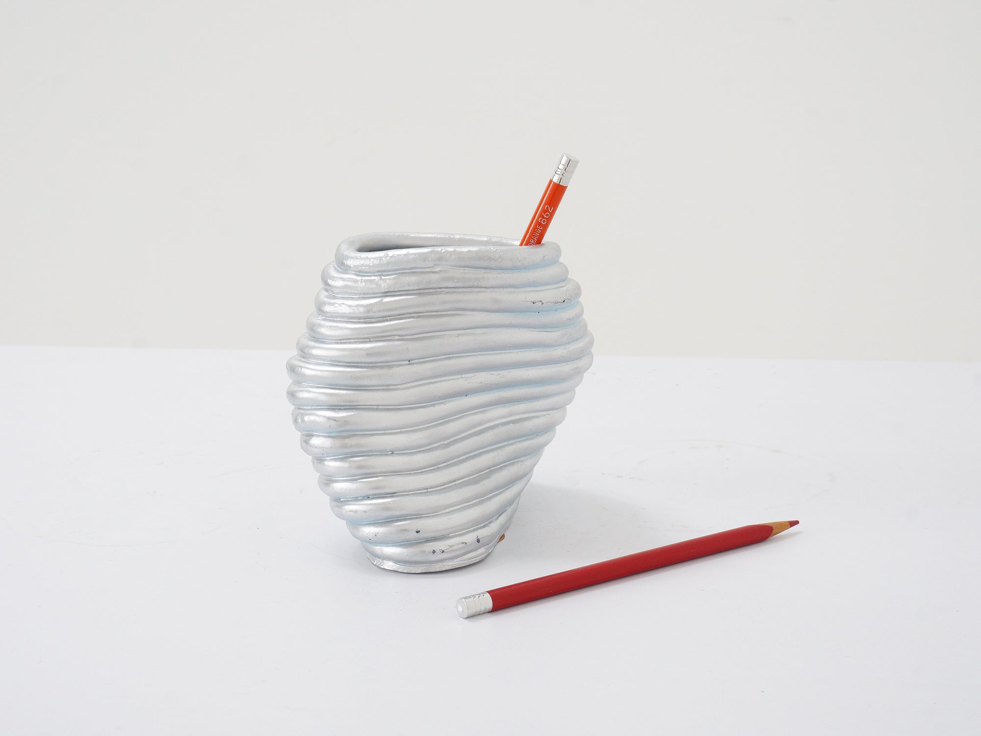 Silver ribbed twist vase with pencils